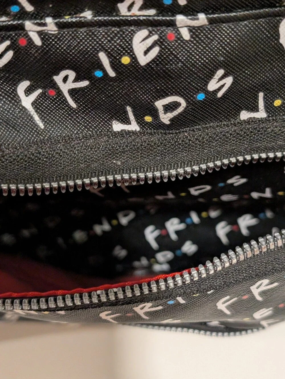 Friends Backpack all over print. need small repair see zoomed in photo